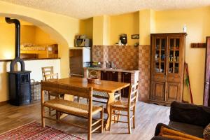 a kitchen with a wooden table and a stove at Agriturismo Giandriale in Tavarone