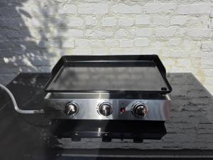a stove top oven sitting on top of a table at Ô Charme Cachet in Arques