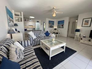 a living room with two couches and a table at Puerto Chico F in Playa Blanca
