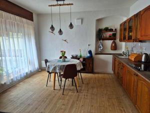 a kitchen with a table and some chairs and a table at Ferienwohnung 1890 in Dettelbach
