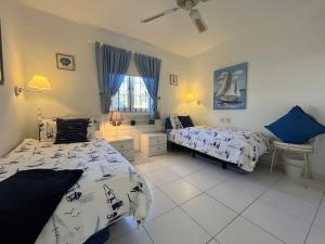 a bedroom with two beds and a window at Puerto Chico F in Playa Blanca +5 photos