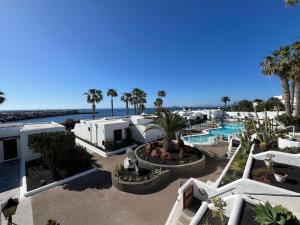 an aerial view of a resort with the ocean in the background at Puerto Chico F in Playa Blanca