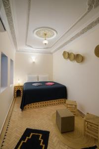 a bedroom with a bed and a table in a room at Riad Medina Unique in Fez