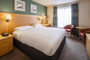 a hotel room with a large bed and a desk at Merton Hotel in St. Saviour +27 photos