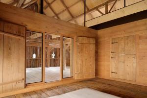 a large room with wooden walls and wooden floors at Alpine Contrapposto in Solčava
