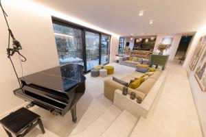 a living room with a piano and a couch at Wok Rooms in Brussels