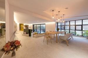 a dining room and living room with a table and chairs at Wok Rooms in Brussels