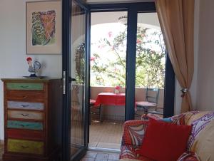 a living room with a sliding glass door and a table at Bohème Valdareina, PISCINE CHAUFFEE, Bénagil-Carvoeiro in Carvoeiro +46 photos
