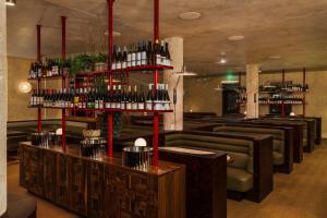 a bar with a bunch of bottles of wine at All Inn Hotel in Denver