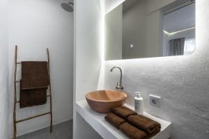 a bathroom with a bowl sink and a mirror at Pyramid Ateliero Hotel Canggu in Canggu +43 photos