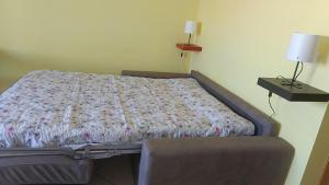 a bed sitting in a room with a bedskirtspectspectspects at Il respiro del mare in Montesilvano