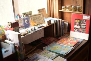 a cluttered desk with books and publications on it at guesthouse碧 in Okinoshima