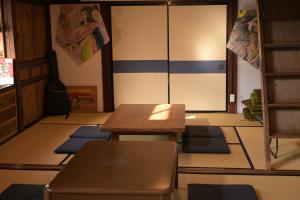 a room with mats on the floor and a table at guesthouse碧 in Okinoshima