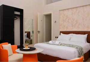 a bedroom with a bed and a table and chairs at Bustani Tulivu in Bungoma