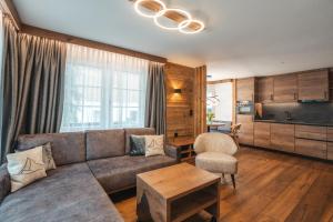 a living room with a couch and a table at La Perle Apartments in Zermatt