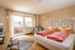 a bedroom with a bed and a large window at B&B Fischerstüble - adults only in Hagnau