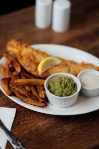 a plate of food with guacamole and french fries at St James Hotel in Grimsby