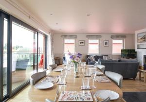 a dining room with a long table and chairs at The Crow's Nest in Woodbridge