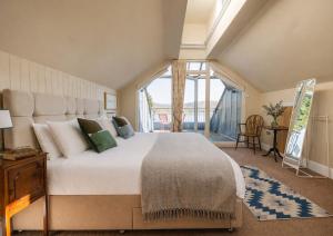 a bedroom with a large bed and a large window at The Crow's Nest in Woodbridge