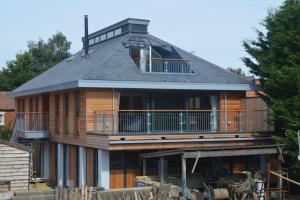 a large wooden house with a gambrel roof at The Crow's Nest in Woodbridge
