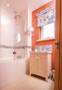 a bathroom with a shower and a tub and a sink at The Crow's Nest in Woodbridge +42 photos