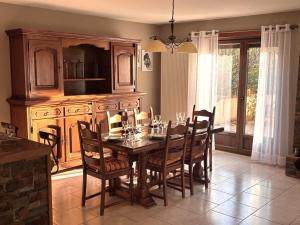 a dining room with a wooden table and chairs at Gite d'arnaud & emilie in Laifour