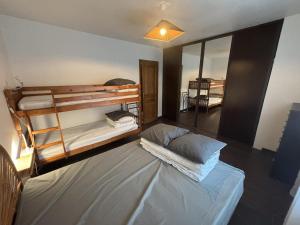 a room with two bunk beds and a large bed at Gite d'arnaud & emilie in Laifour