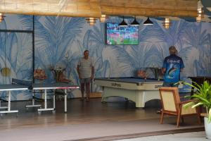 two men standing in a room with a pool table at Mona Luxe Apartment Hoi An in Hà My Tây (2) +214 photos