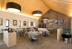 a restaurant with tables and chairs in a room at Hostellerie Stafelter in Walferdange +36 photos