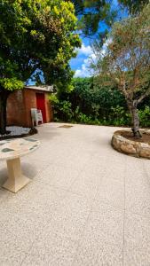 a stone patio with a bench and a tree at Villa Lorelia in La Adrada +23 photos