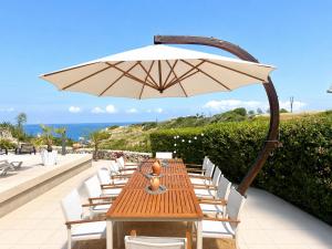 a wooden table and chairs with an umbrella at Golden Sunset Villa in Tatlisu