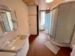 a bathroom with a sink and a mirror at ヨゴダステイアンドリトリート Yogoda Stay & Retreat in Ina