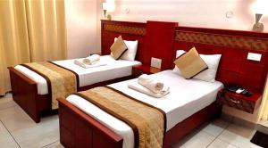 a hotel room with two beds in a room at ROYAL RESIDENCY Ac in Virudunagar +10 photos