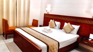 a hotel room with a bed and a chair at ROYAL RESIDENCY Ac in Virudunagar