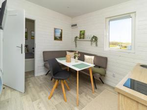 a small dining room with a table and chairs at Sonnenkap Camping in Prenzlau