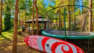 a play park with a trampoline and a play tent at Дом в лесу 1dom club in Protsev