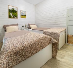 two beds in a room with white walls at Sonnenkap Camping in Prenzlau