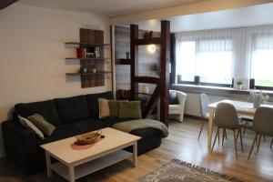 a living room with a couch and a table at Pension Danzer in Oberhof