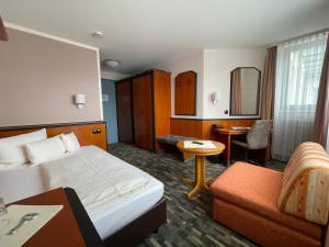 a hotel room with a bed and a desk at Advantage Appartements Hotel in Nuremberg