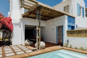 a house with a swimming pool and a pergola at Sterretjie in Paternoster