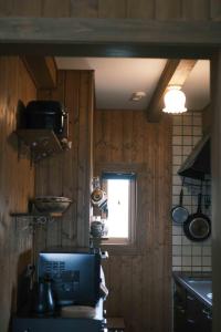 a kitchen with wood paneled walls and a window at Lakeview Etsu in Lake Toya +15 photos