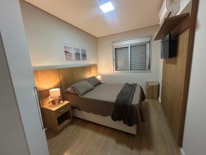 a small bedroom with a bed and a window at Apartamento luxo próximo Alphaville com vaga -5 min estação trem -ótima localização in Osasco +25 photos