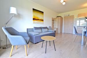 a living room with a couch and chairs and a table at Chmielowa2 - Apartamenty in Rowy