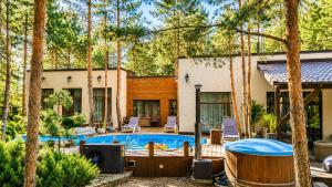 a house with a swimming pool in a yard at Дом в лесу 1dom club in Protsev