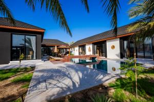 an external view of a house with a swimming pool at The Reef Villa in Bahlāʼ