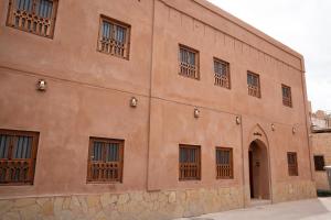 a large brick building with windows and a door at بيت المقصرة Almuqasrah house in Nizwa