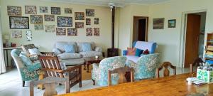 a living room with chairs and a couch and a table at Rivers Rest in Seafield