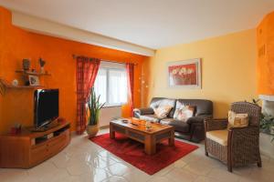 a living room with a couch and a tv at Chambres D'hôtes Soizic in Paimpol