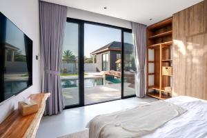 a bedroom with a view of a swimming pool at The Reef Villa in Bahlāʼ +87 photos