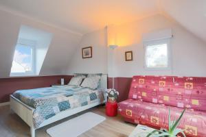 a bedroom with a bed and a couch at Chambres D'hôtes Soizic in Paimpol